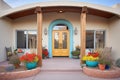 pueblo revival home, arched entryway, flowers