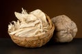 Pueraria mirifica or white kwao krua fruit and dried slices on black background