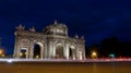 Puerta de Alcala (Alcala Gate) at night with cars in Madrid