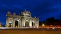 Puerta de Alcala (Alcala Gate) at night with cars in Madrid