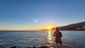 Puerto de la Cruz - Rear view of silhouette of woman watching the sunrise at port of Puerto de la Cruz Royalty Free Stock Photo