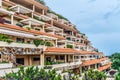 Building with terraces and red tiled roofs of Apartamentos Bahia Playa Hotel