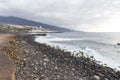 Puerto de la Cruz, Tenerife, Canary Islands - view of colorful houses, sea and volcanic-sand beach. Black beach in tenerife Royalty Free Stock Photo