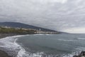 Puerto de la Cruz, Tenerife, Canary Islands - view of colorful houses, sea and volcanic-sand beach. Black beach in tenerife Royalty Free Stock Photo