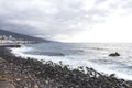 Puerto de la Cruz, Tenerife, Canary Islands - view of colorful houses, sea and volcanic-sand beach. Black beach in tenerife Royalty Free Stock Photo