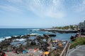 Puerto de la Cruz, Tenerife, Spain, August 7, 2022 - View of the coast and town with lava stones in the sea