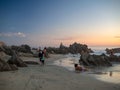 Puerto Escondido, Oaxaca, Mexico, South America: [Sunset at the local beach, lighthouse, crowdwed beach, tourist destination] Royalty Free Stock Photo