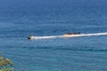 Puerto Galera, Philippines - April 4, 2017: A man riding jet ski in the sea, people on banana boat near White beach Royalty Free Stock Photo