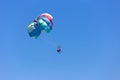 Puerto Galera, Sabang, Philippines - April 4, 2017: Two people parasailing in a blue sky Royalty Free Stock Photo