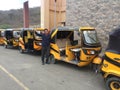 Puerto Lopez - Ecuador 3-5-2019: A line of yellow tuktuk taxis waiting for passengers
