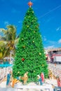 Puerto Morelos, Mexico - January 10, 2018: Outdoor view of a huge christmast tree with a manger in the base in the park Royalty Free Stock Photo