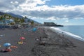 Puerto Naos beach an sunbathing people at beach with black lava sand at La Palma, Canary Island, Spain
