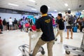 Puerto Princesa, Philippines - 30 Nov 2018: tourist crowd and trolley carrier in airport. Airport service support team