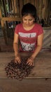 Young latin woman selecting cacao beans. Separating cocoa beans is a part of t