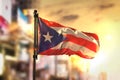 Puerto Rico Flag Against City Blurred Background At Sunrise Back