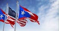 Puerto Rico and United States flags waving on a clear day Royalty Free Stock Photo