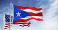 Puerto Rico and United States flags waving on a clear day Royalty Free Stock Photo