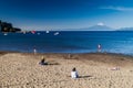 PUERTO VARAS, CHILE - MAR 23: People on a bach of Llanquihue lake in Puerto Varas town. Osorno volcano in the background
