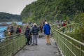 PUERTO VARAS, CHILE, SEPTEMBER, 23, 2018: Tourists walking over a bridge close to los Saltos de Pertrohue, in Chile