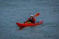 PUERTO VARAS, CHILE, SEPTEMBER, 23, 2018: Unidentified man on orange kayak enjoying the day in the water in Puerto Varas