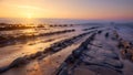 Warm sunset at Barrika beach with several rows of rocks Royalty Free Stock Photo