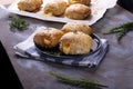 Puff buns with cheese on the ceramic plate and on the baking parchment