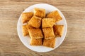 Puff cookies in plate on wooden table. Top view