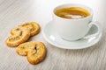 Puff cookies with poppy, black coffee in cup on saucer on wooden table Royalty Free Stock Photo