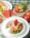 Puff pastries with strawberries and berry sauce on a white plate. Smorrebrod, traditional Danish open sanwich. Royalty Free Stock Photo