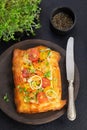 Homemade Puff pastry appetizer tartlet with shrimps, prawns, tomatoes, avocado,vegetables and microgreens on dark background with Royalty Free Stock Photo