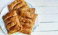 Puff pastry apple pastry turnovers for dessert on a white wooden table with copy space Royalty Free Stock Photo