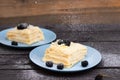 puff pastry with blackberries sprinkled with powdered sugar on a wooden background Royalty Free Stock Photo