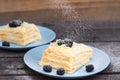 puff pastry with blackberries sprinkled with powdered sugar on a wooden background Royalty Free Stock Photo