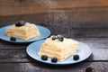 puff pastry with blackberries sprinkled with powdered sugar on a wooden background Royalty Free Stock Photo