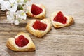 Puff pastry cookies in heart shape filled with strawberries Royalty Free Stock Photo