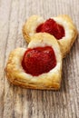 Puff pastry cookies in heart shape filled with strawberries. Royalty Free Stock Photo