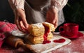 Puff pastry dessert red jam hand viburnum cherry cup coffee black background