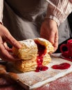 Puff pastry dessert red jam hand viburnum cherry cup coffee black background