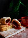 Puff pastry dessert red jam viburnum cherry cup coffee black background