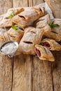 Puff pastry filled with cherry jam close-up. Vertical Royalty Free Stock Photo