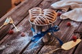 Puff pastry with jam sprinkled with powdered sugar in a bucket decorated with a blue ribbon on a wooden table with Royalty Free Stock Photo