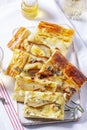 Puff pastry pie with cheese, pears, nuts and honey, served with champagne. Royalty Free Stock Photo