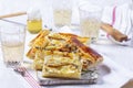 Puff pastry pie with cheese, pears, nuts and honey, served with champagne. Royalty Free Stock Photo