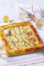 Puff pastry pie with cheese, pears, nuts and honey, served with champagne. Royalty Free Stock Photo