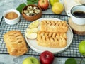 Puff pastry pies with apples, brown sugar and eggs. Baking with apple. Freshly baked apple rolls made from puff Royalty Free Stock Photo