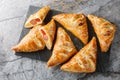 Puff pastry Pigs in a blanket pies with sausage, cheese, sesame and pepper close-up on a marble board. Horizontal top view Royalty Free Stock Photo