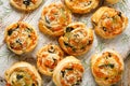 Puff Pastry Pinwheels stuffed with salmon, cheese and spinach on a wooden background