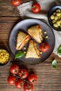 Puff pastry pizza triangle rolls stuffed with tomato sauce, ham, cheese, corn, olives and sprinkled with sesame seeds Royalty Free Stock Photo