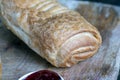 puff pastry with red strawberry jam on a wooden table Royalty Free Stock Photo