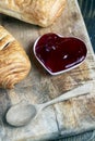 puff pastry with red strawberry jam on a wooden table Royalty Free Stock Photo
